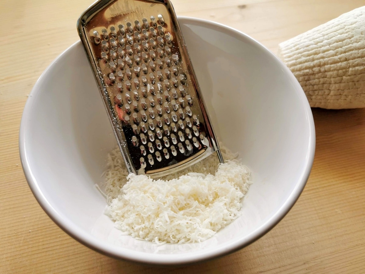 hard ricotta cheese grated into white bowl