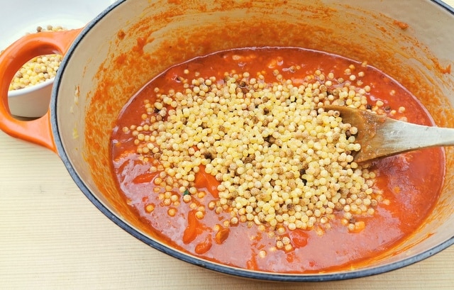 fregola added to the tomato sauce  in a Dutch oven