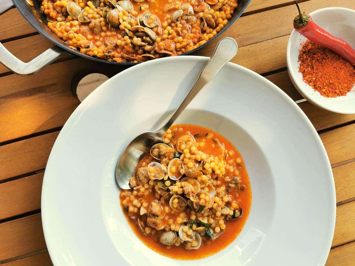 Fregola with clams in a bowl