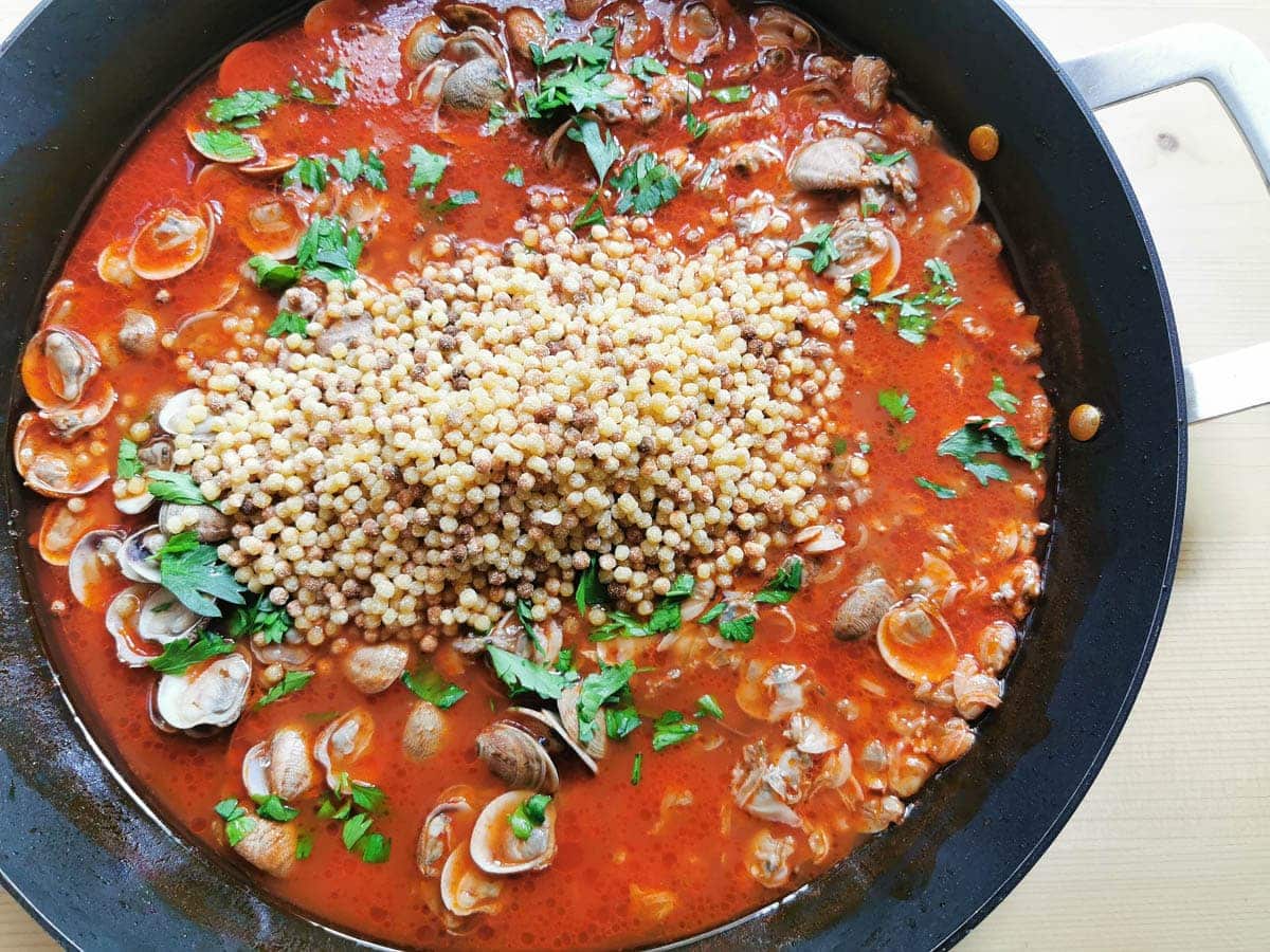 Fregola added to the clam and tomato sauce