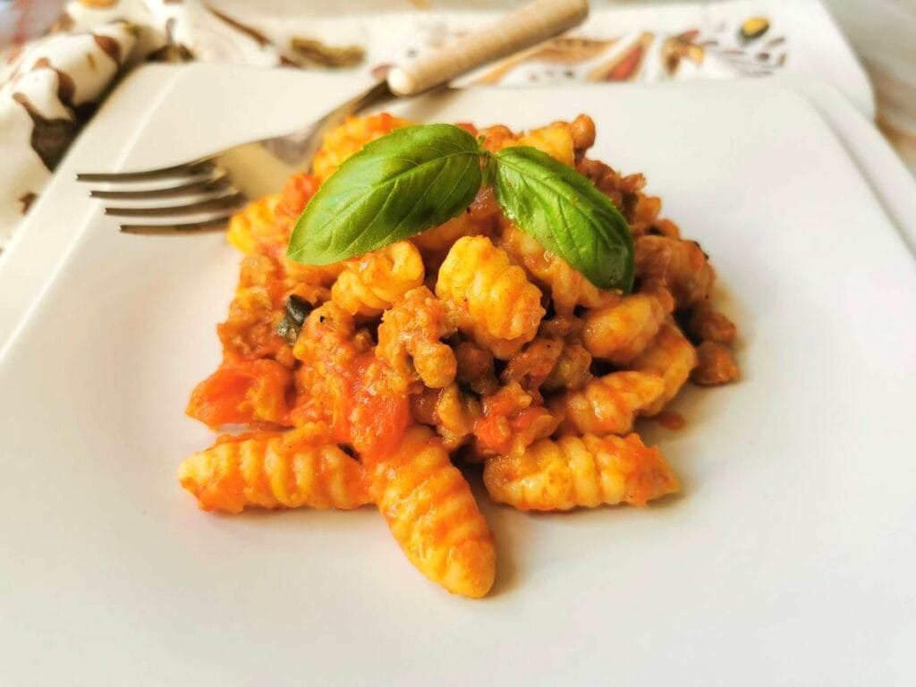 Malloreddus alla Campidanese with sausage, saffron and tomatoes.