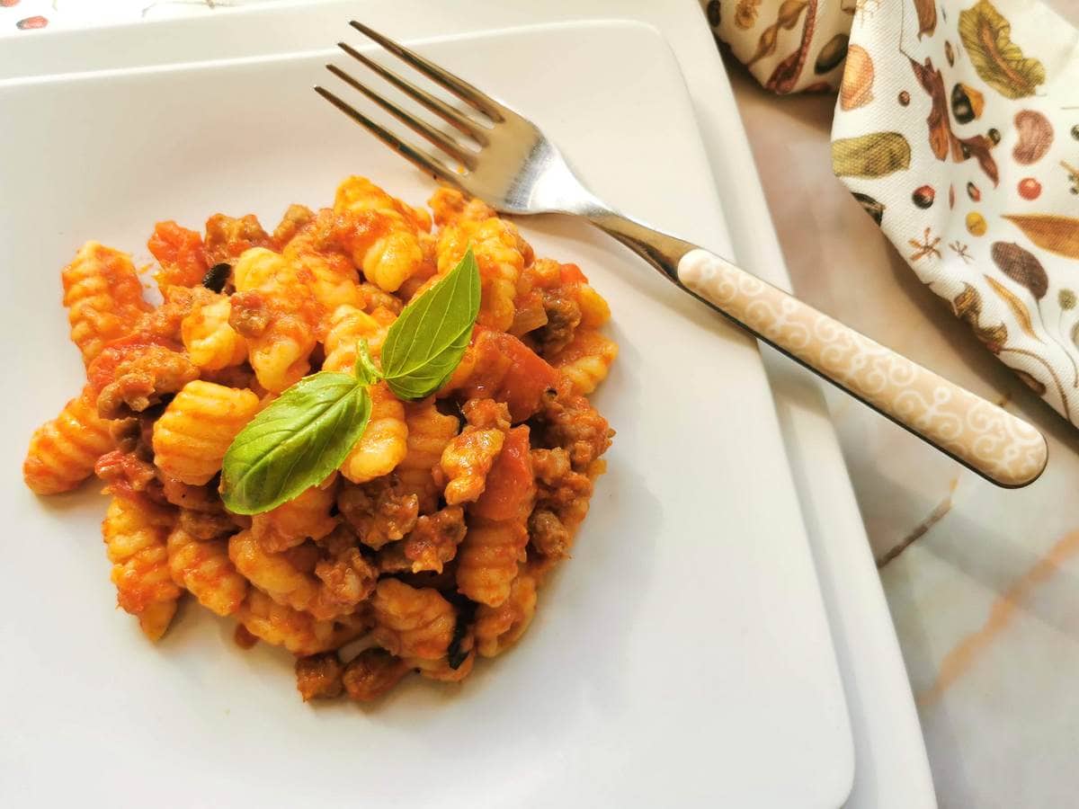 Homemade Sardinian gnocchi (malloreddus) with sausages alla Campidanese.