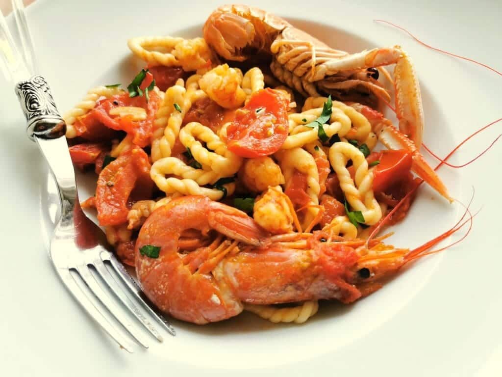 Sardinian lorighittas pasta with prawns and scampi. Seafood pasta recipe from Sardinia