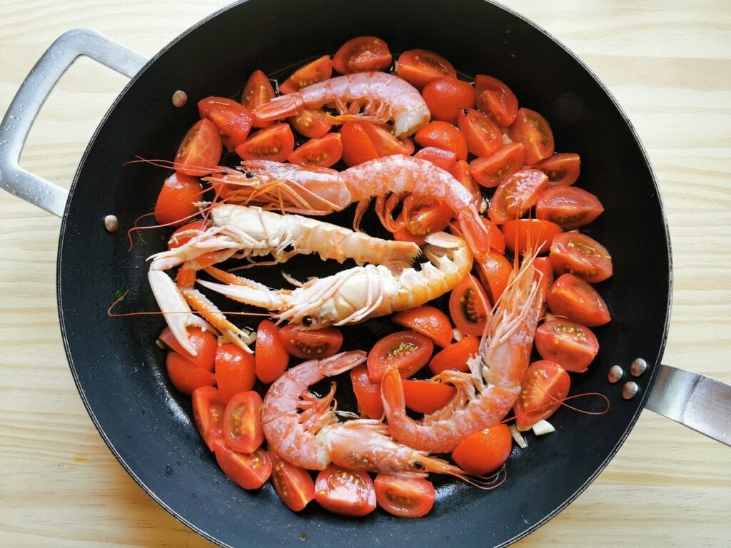 whole prawns and scampi inskillet with tomatoes