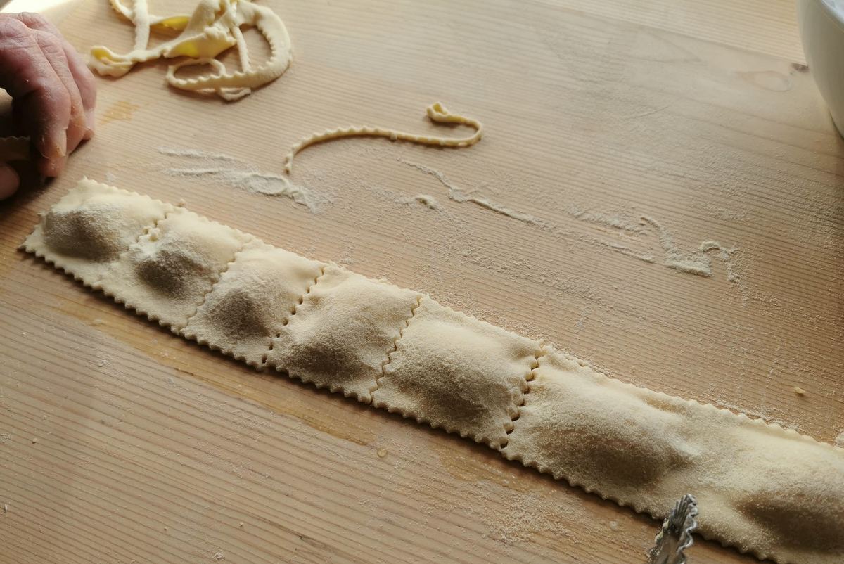 ricotta ravioli being cut into squares