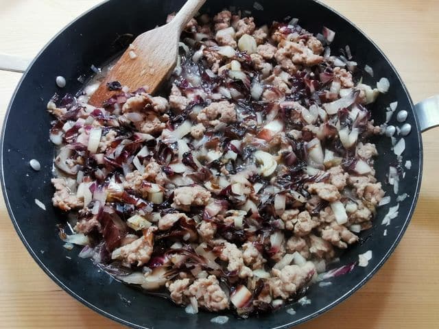 cooked radicchio, sausage meat and onions in skillet