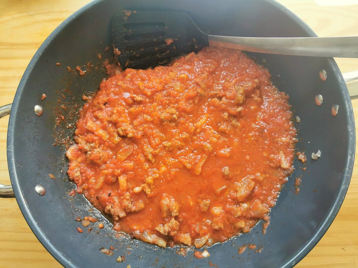 Ready sausage ragu for pasta alla zozzona in skillet.