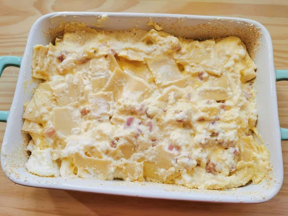 Uncooked schinkenfleckerl (pasta and ham casserole) in oven dish