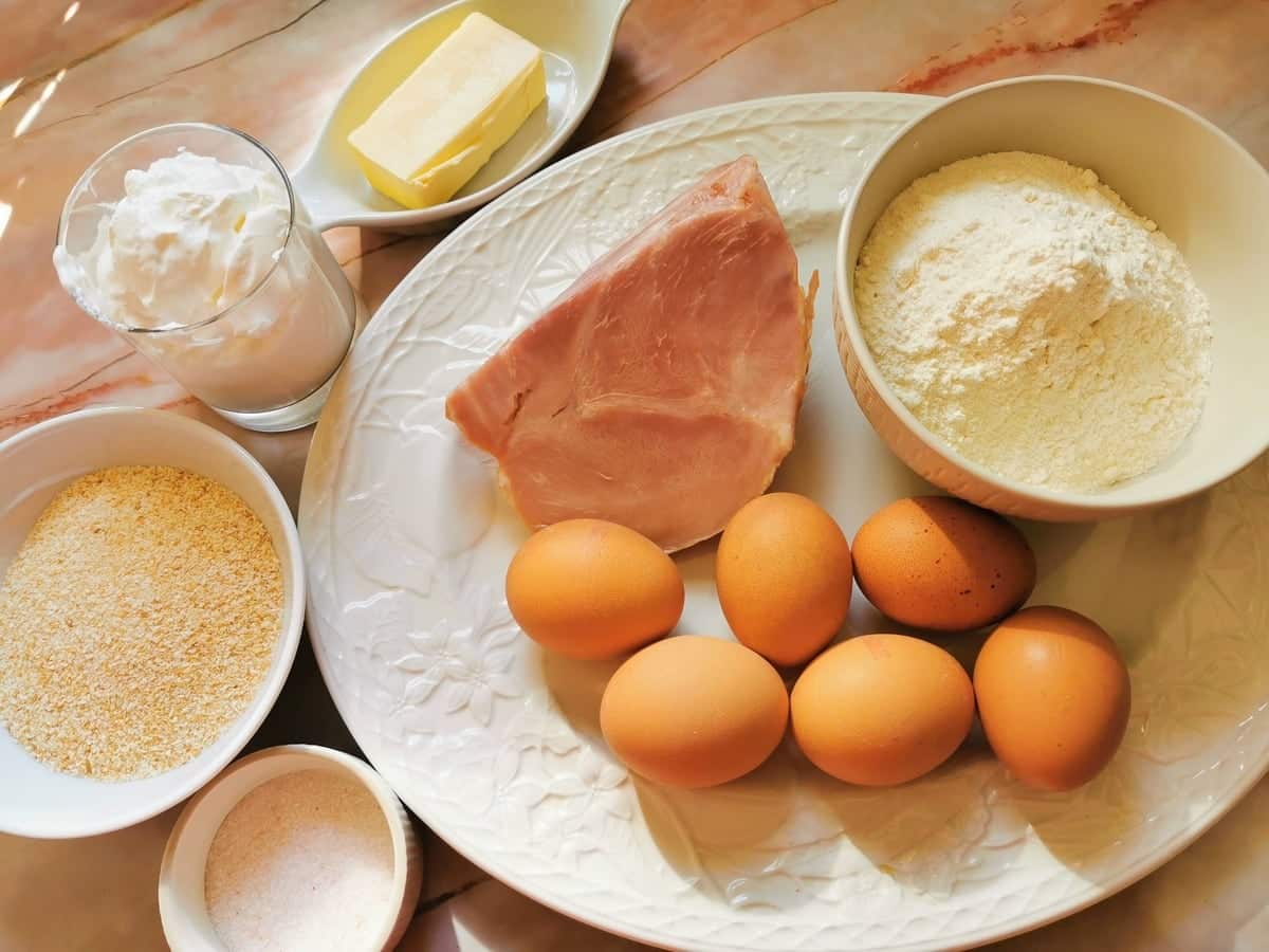 Ingredients for schinkenfleckerl on white plate.