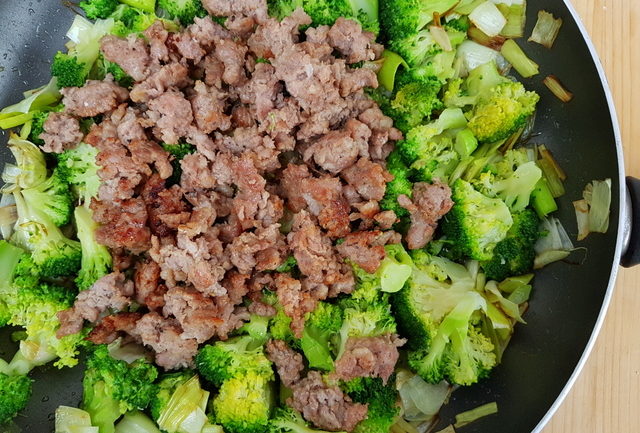 broccoli, leeks and chopped sausage in frying pan
