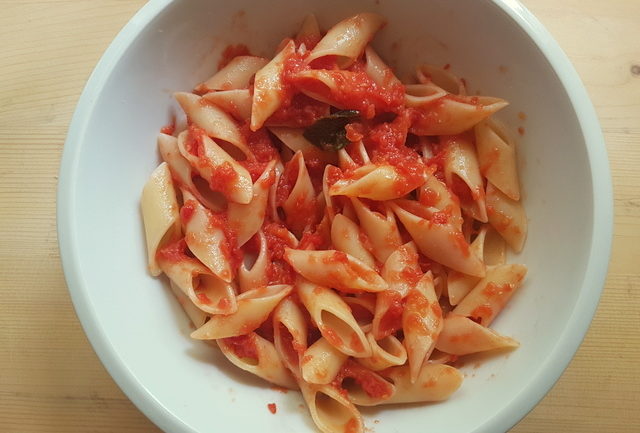 genovesone pasta with tomato sauce in white bowl