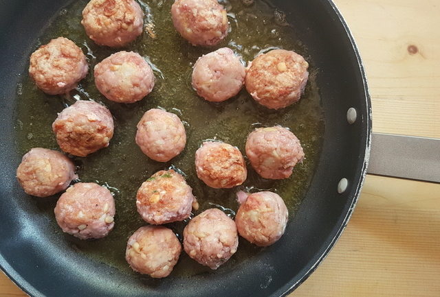 tuna meatballs cooking in frying pan