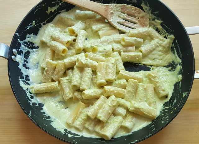 occhio di lupo pasta mixed with ricotta pistachio sauce in frying pan