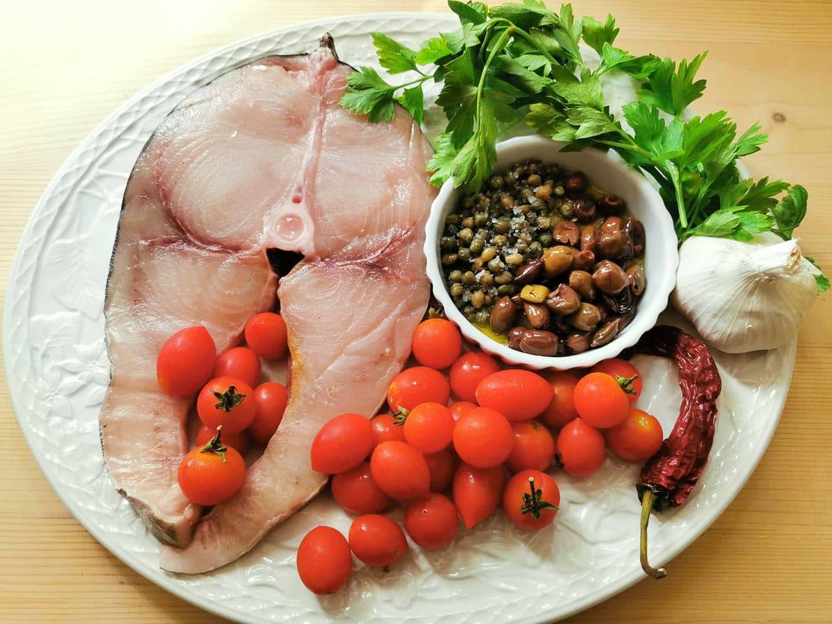 ingredients for strozzapreti with sword fish on a white plate