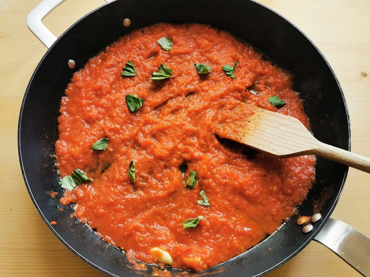 Southern Italian simple tomato sauce with tomatoes, basil and garlic in skillet