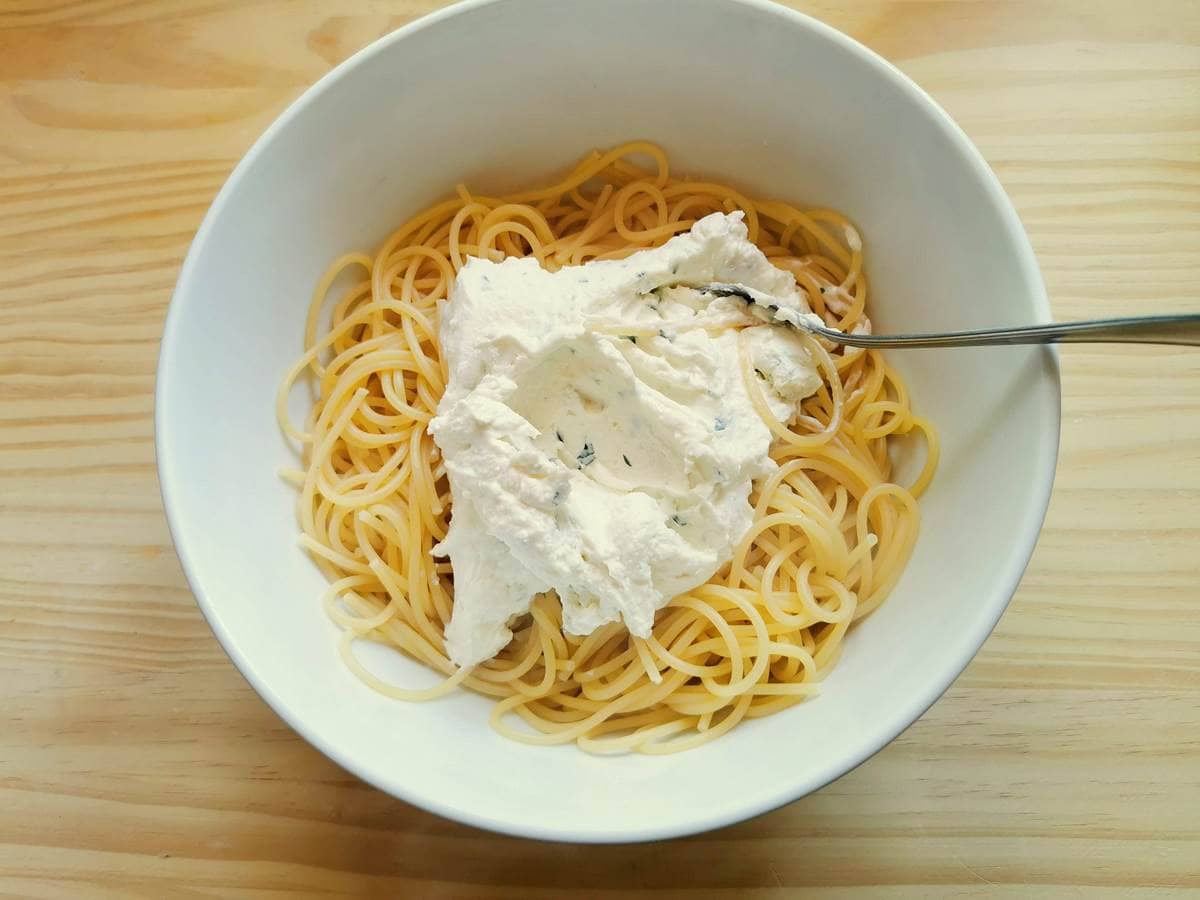 Mixing the lemon ricotta mixture into the pasta