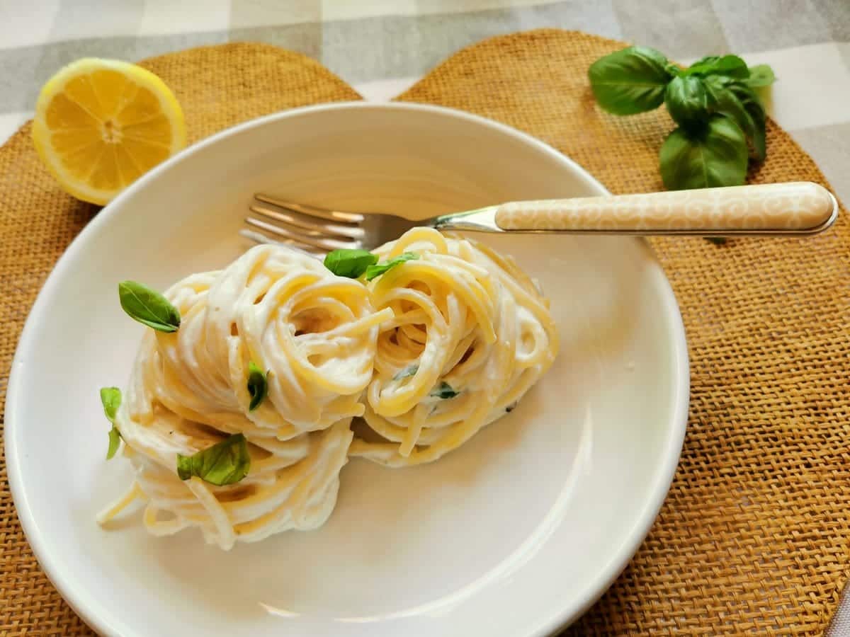 Lemon ricotta pasta served on a plate with basil