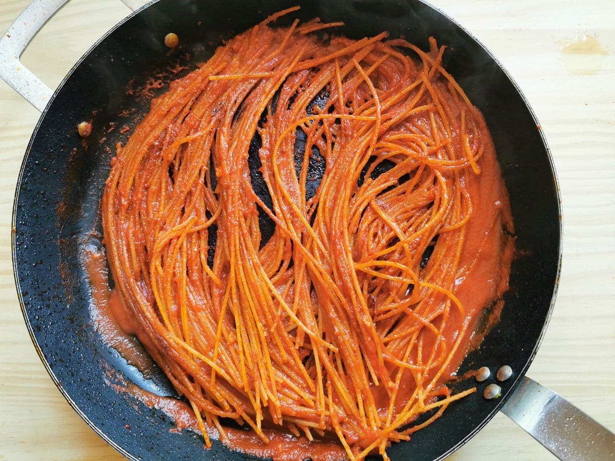 spaghetti all'assassina cooking in skillet