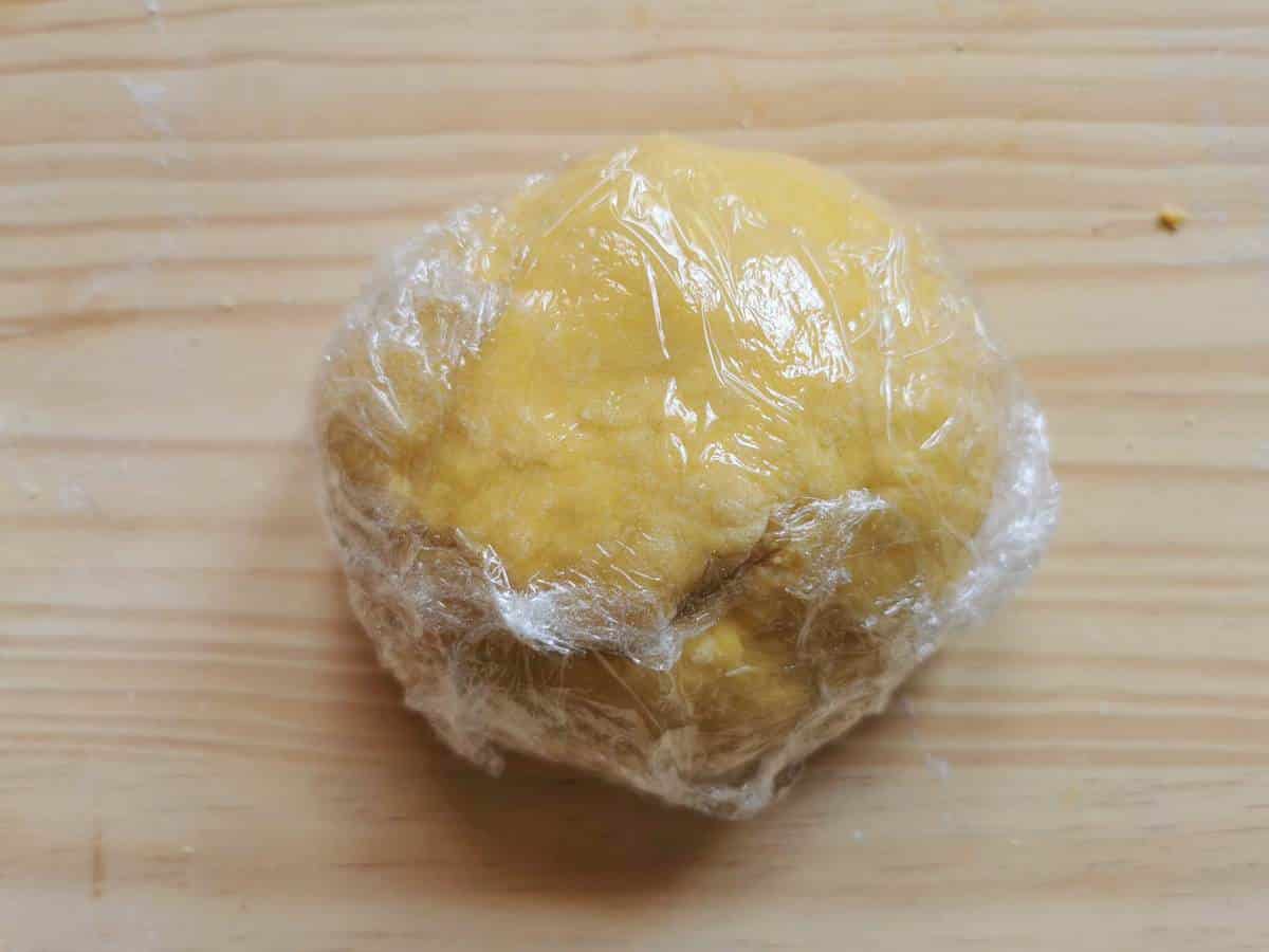 Ready spaghetti alla chitarra dough rolled in a ball and wrapped in clingfilm.