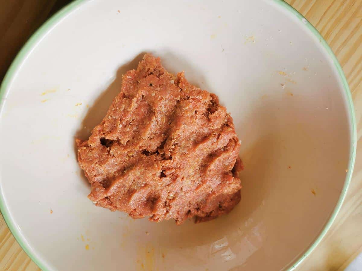 Ready meatball mixture in a large bowl.