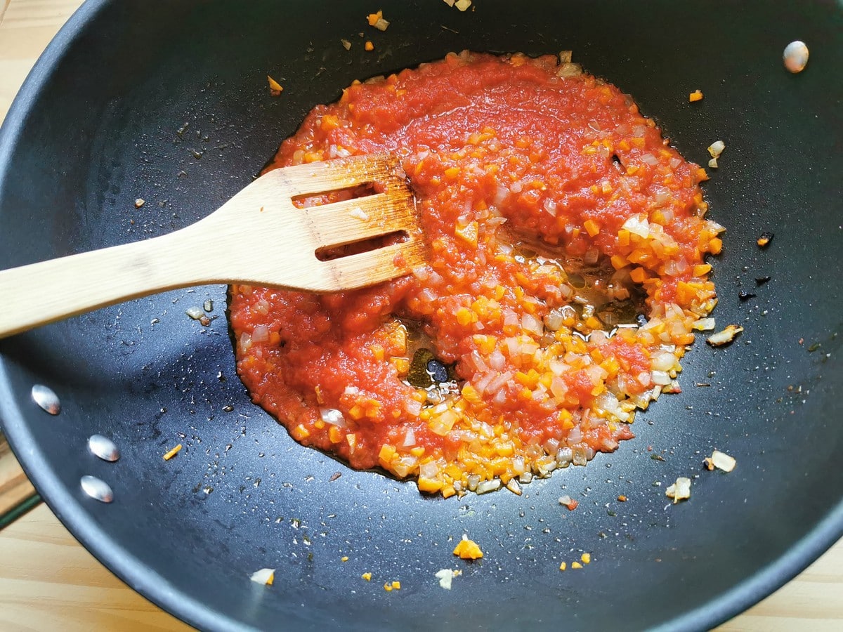 Chopped vegetables in deep frying pan with added tomato passata.