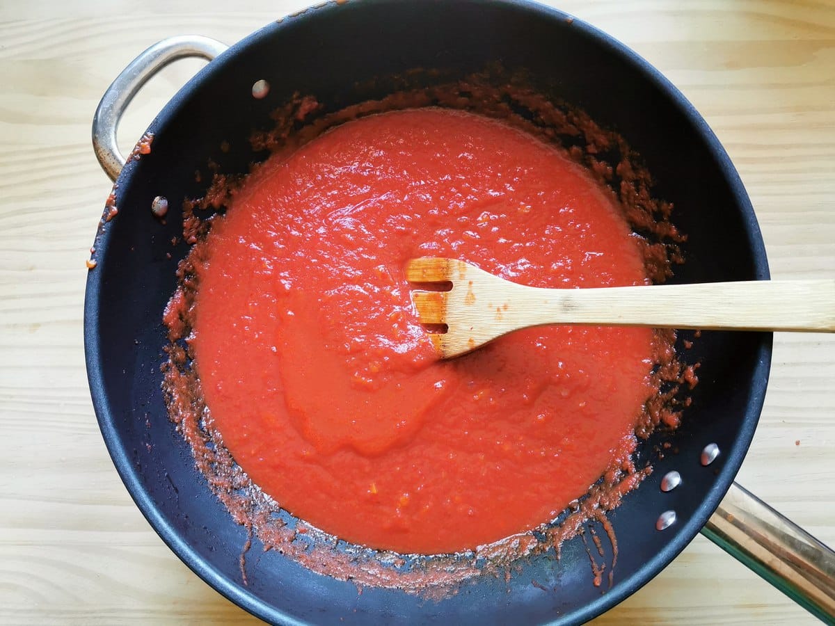 Ready tomato sauce for spaghetti alla chitarra recipe in deep frying pan.