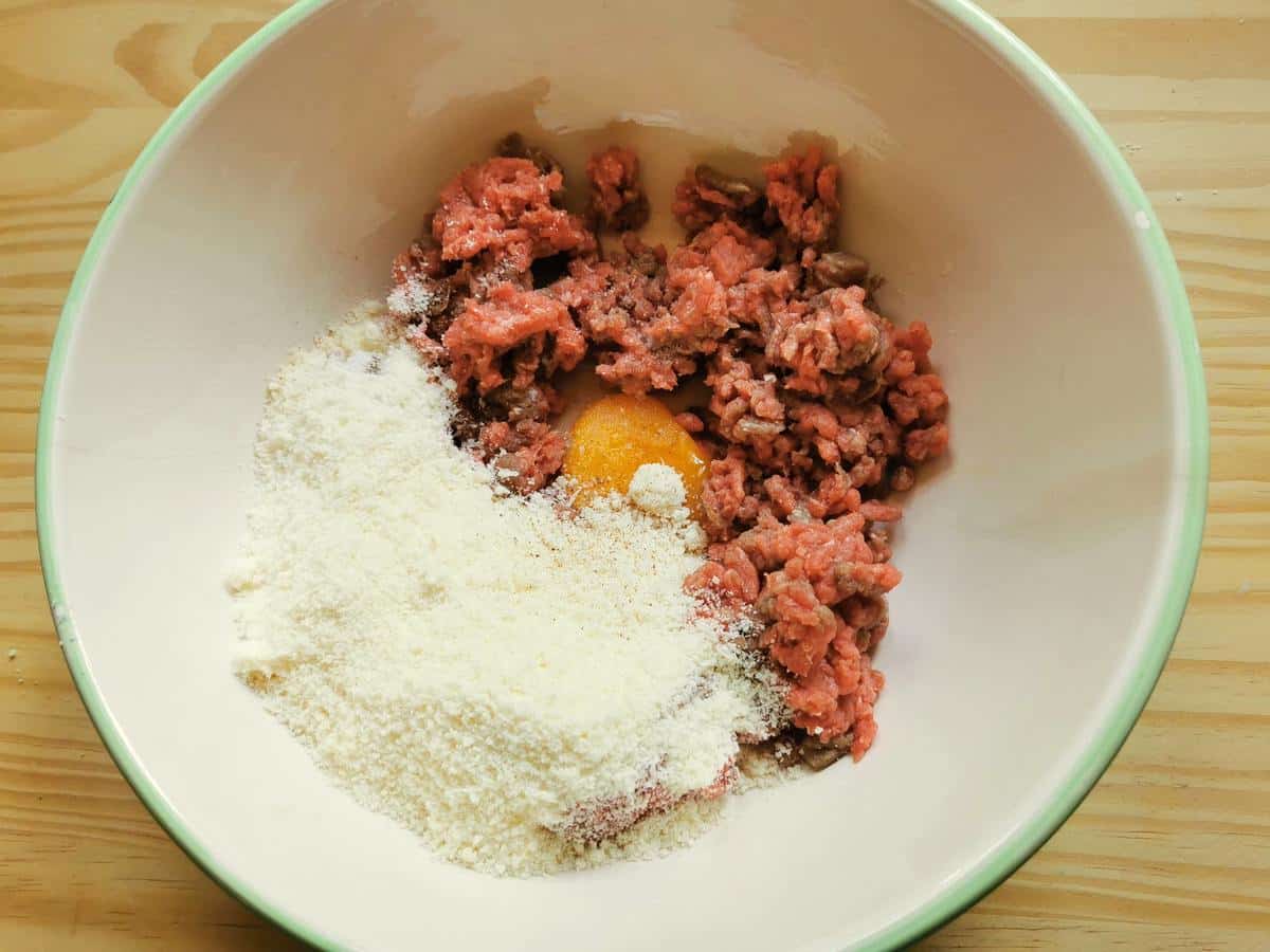 Ingredients for tiny meatballs in a large bowl.