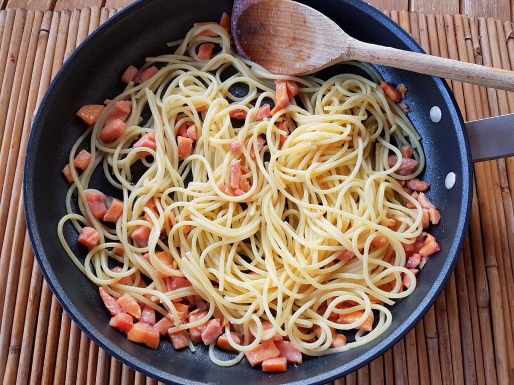 cooked spaghetti and smoked trout in skillet