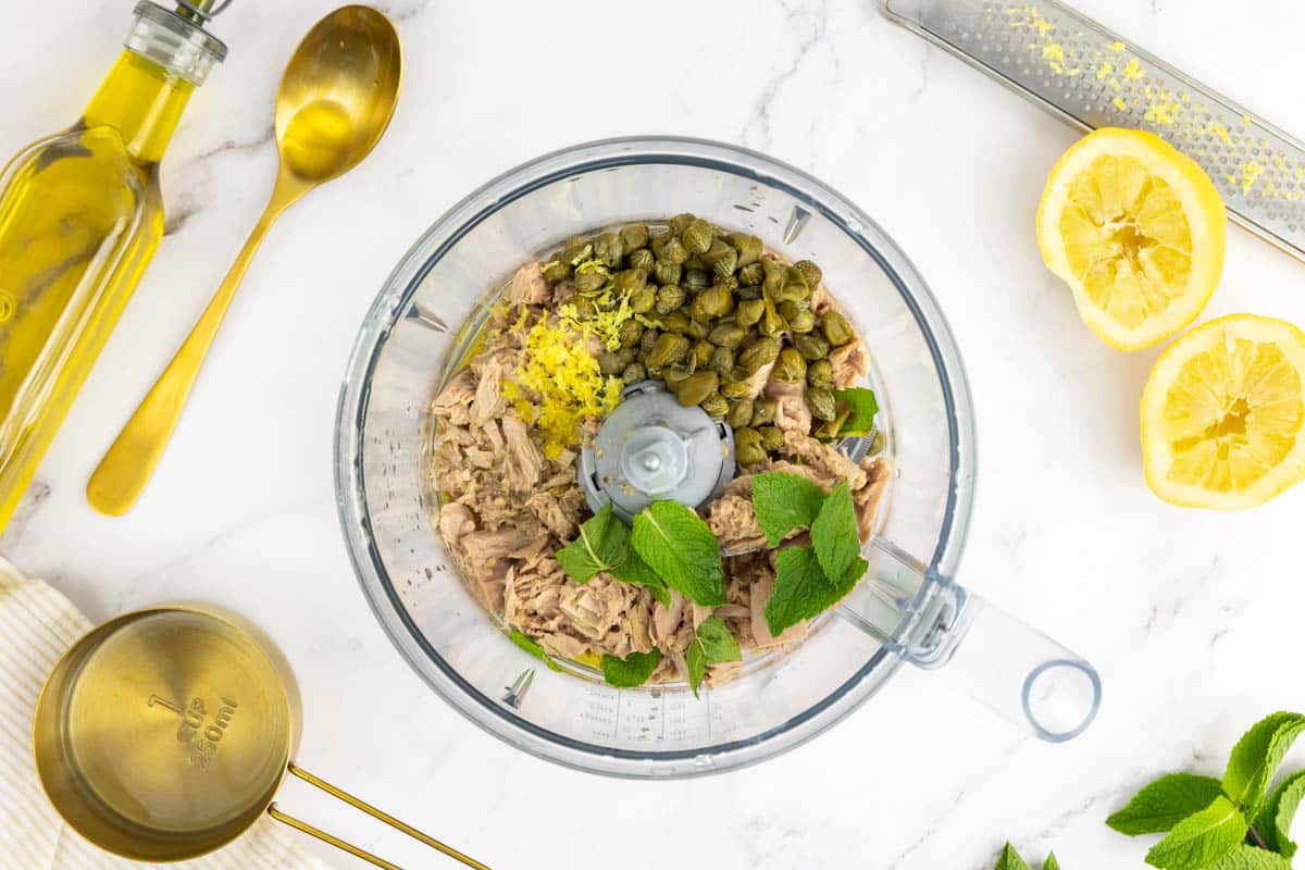 Canned tuna, capers, mint, extra virgin olive oil, lemon and lemon rind in a food processor