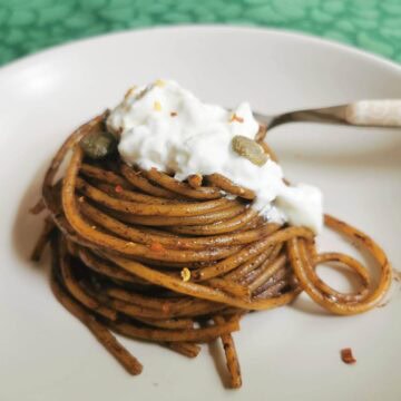 Spaghetti with black garlic sauce and burrata