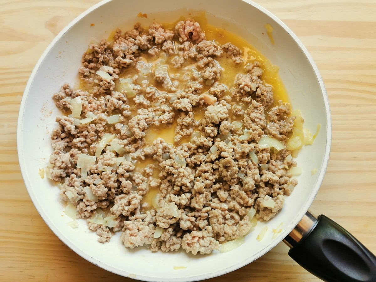 ground veal and onions cooking in frying pan