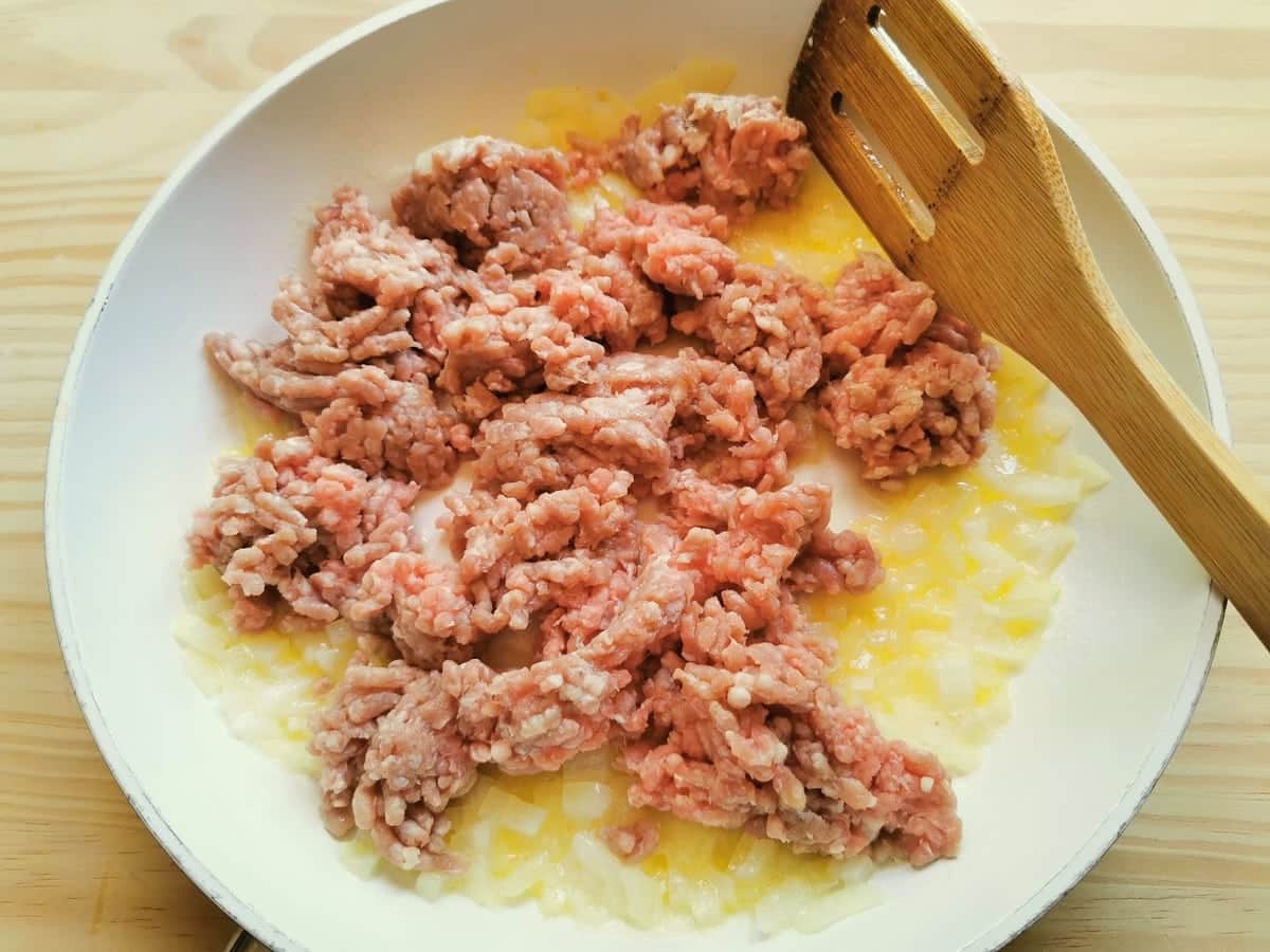 finely chopped onion and ground veal in frying pan with butter