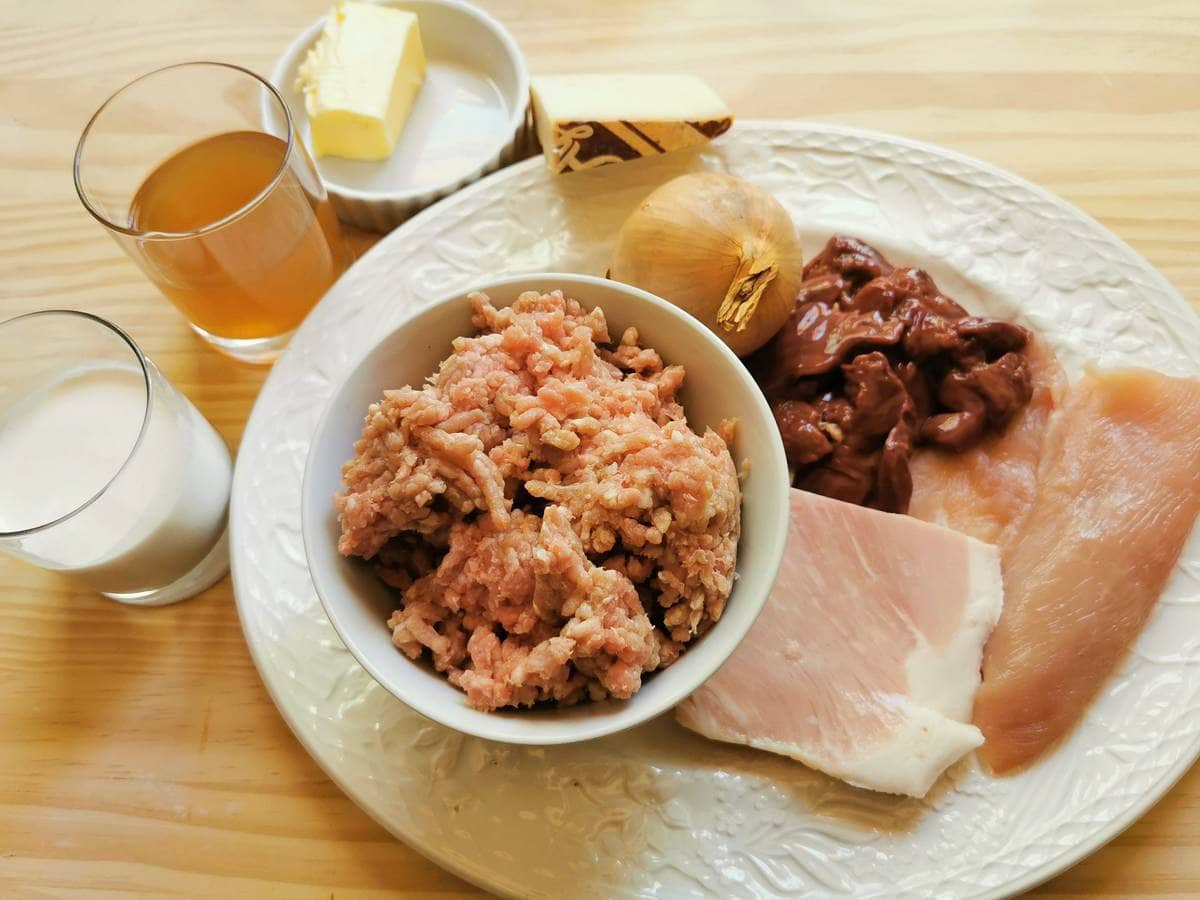 ingredients for stuffed paccheri al forno on white plate.