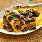 Tagliatelle pasta with chicken livers on a plate with a fork