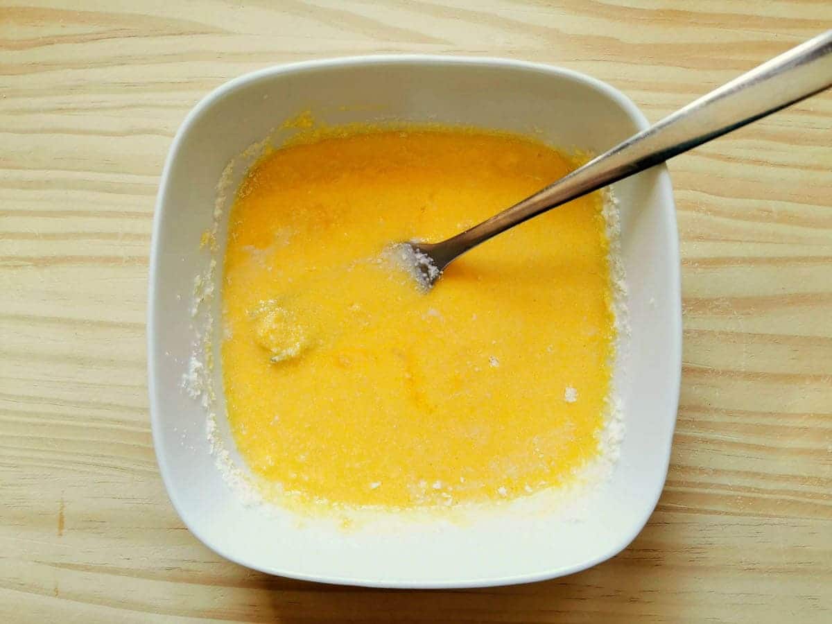 Egg yolk and parmesan mixed together in a bowl