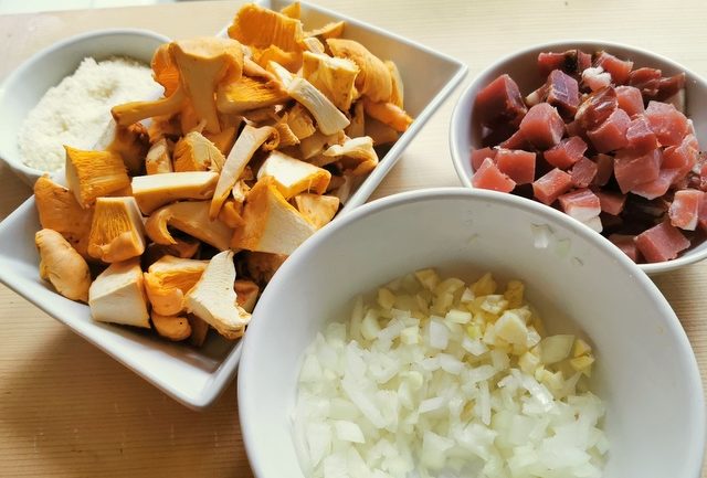 chopped onions and garlic with diced speck and chopped chanterelle mushrooms