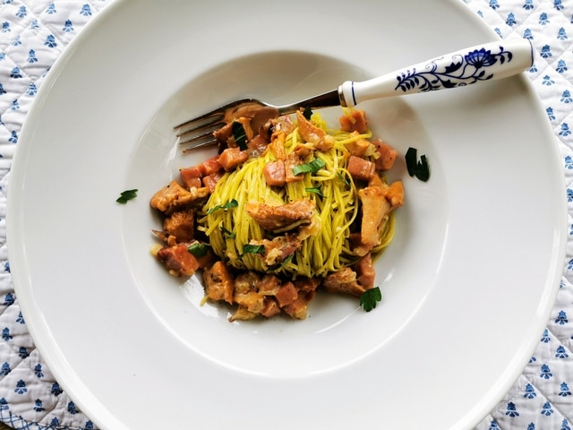 Pasta with chanterelle mushrooms and speck.