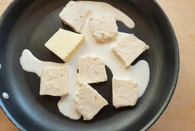 Taleggio, cream and butter in frying pan