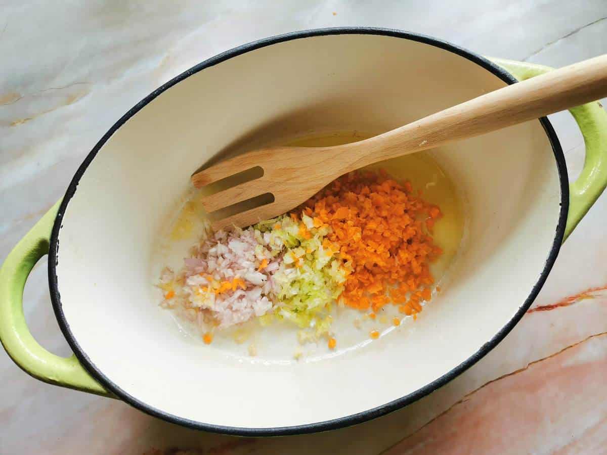 Chopped shallot, celery and carrot with olive oil in Dutch oven.