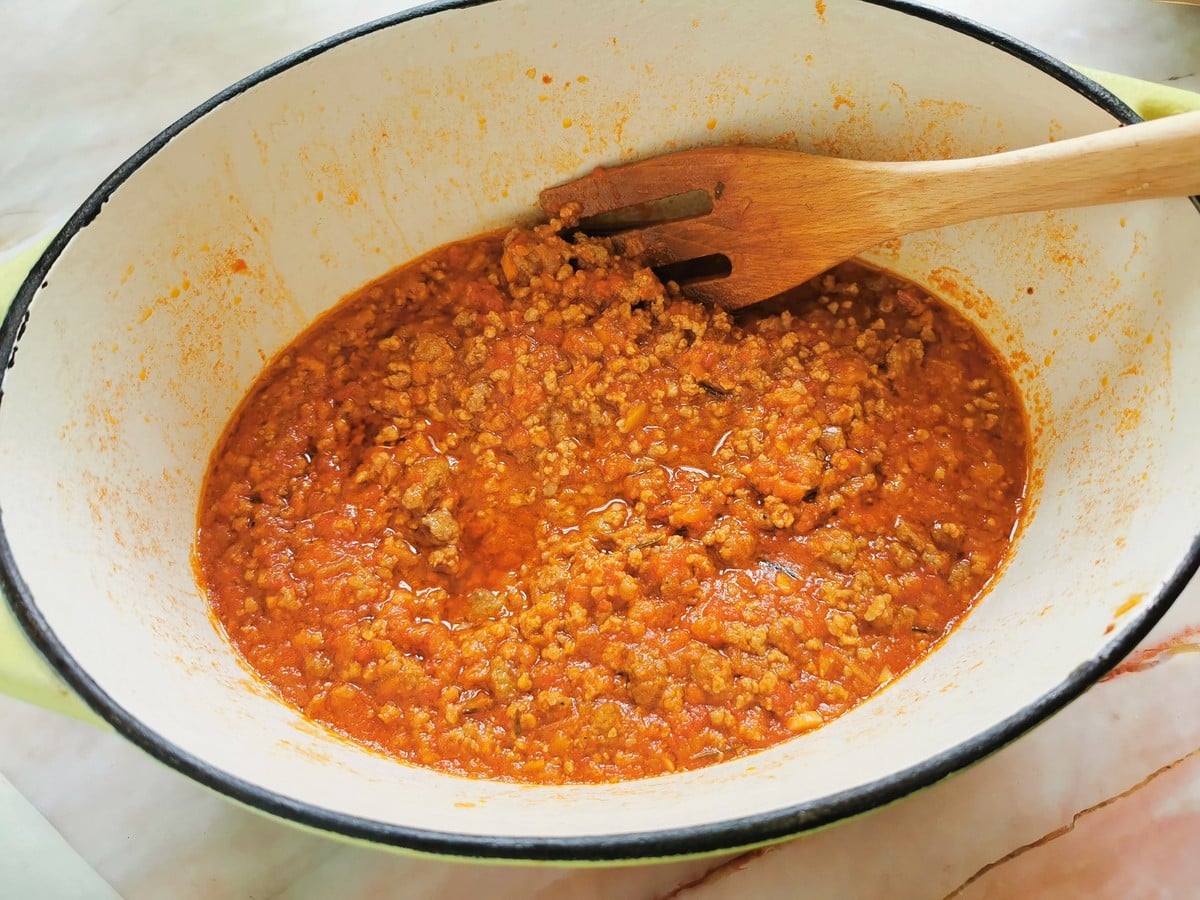 Ready beef sausage ragu in Dutch oven.