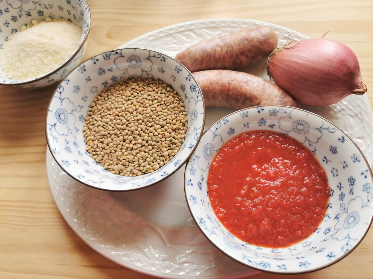 Ingredients for Umbrian lentil and sausage pasta sauce on white plate.