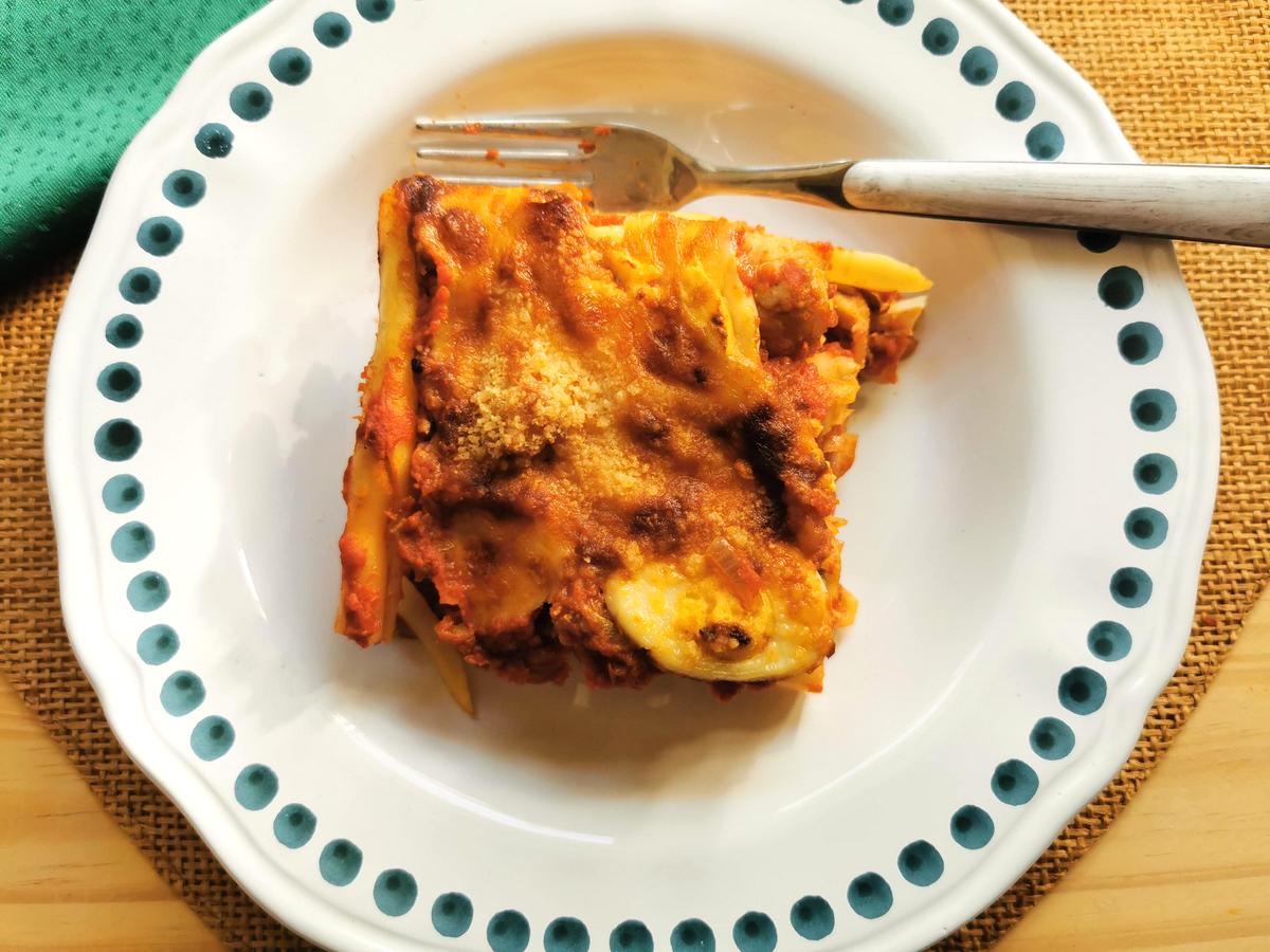 One portion of baked ziti alla lucana in white bowl.