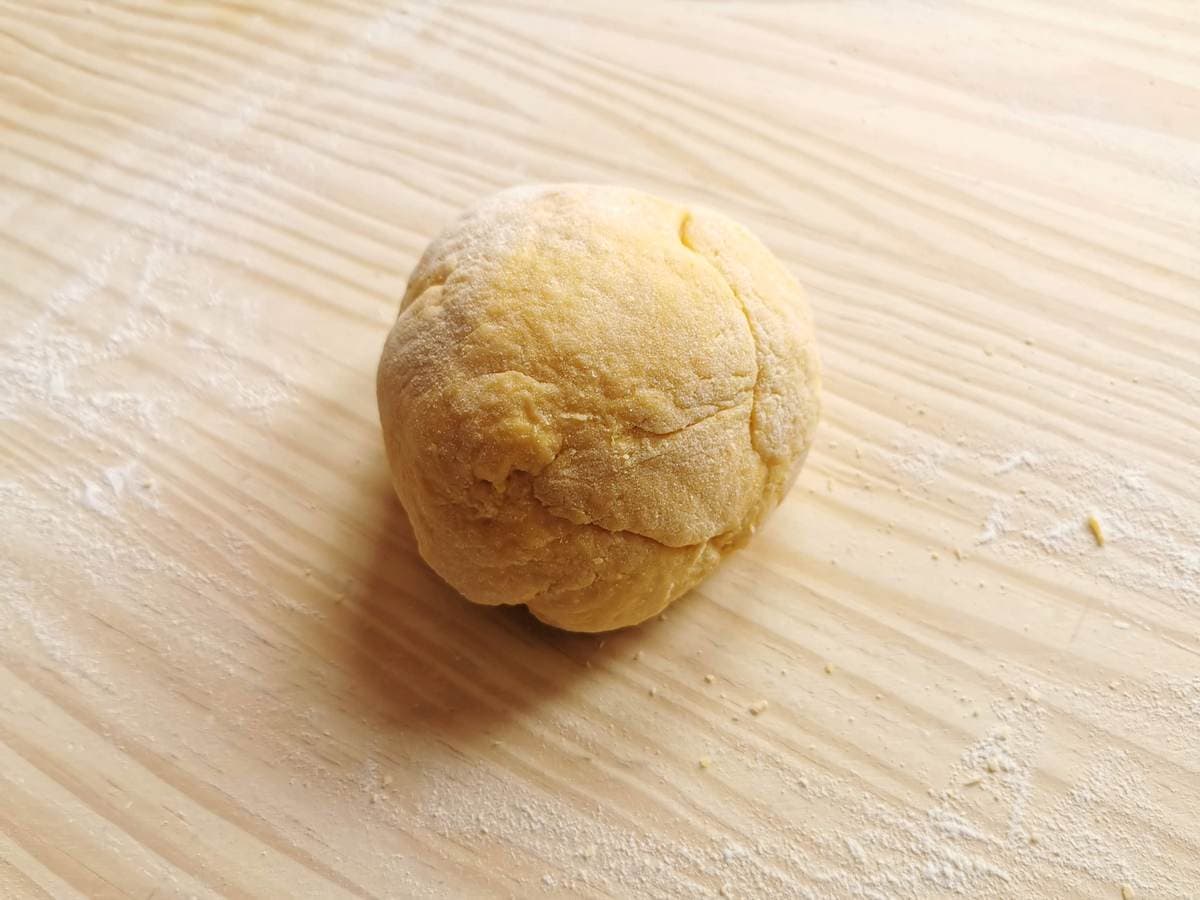 ball of ravioli dough on pastry board