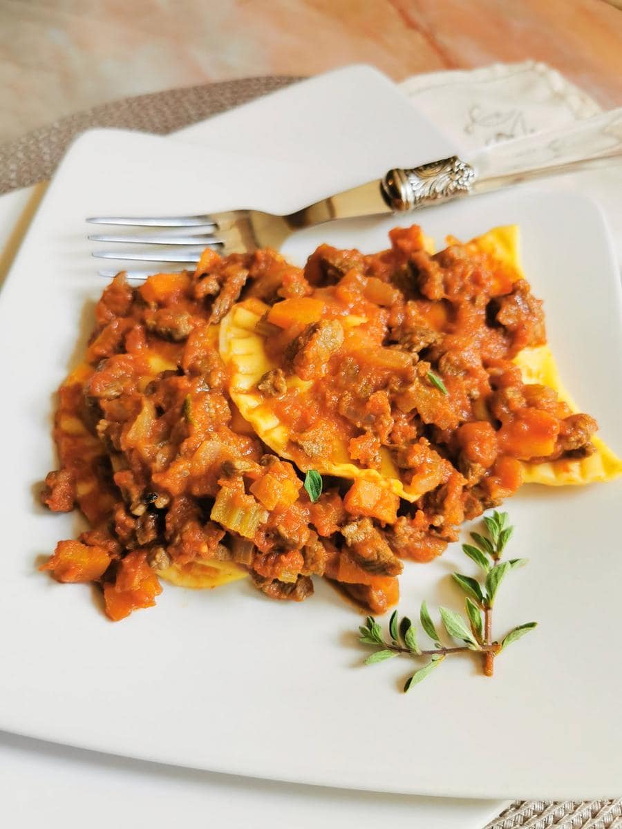 traditional Italian homemade ricotta ravioli with meat sauce