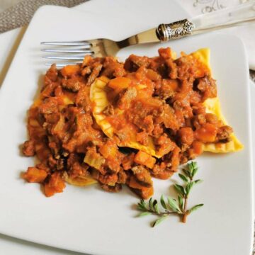 traditional homemade ricotta ravioli with meat sauce