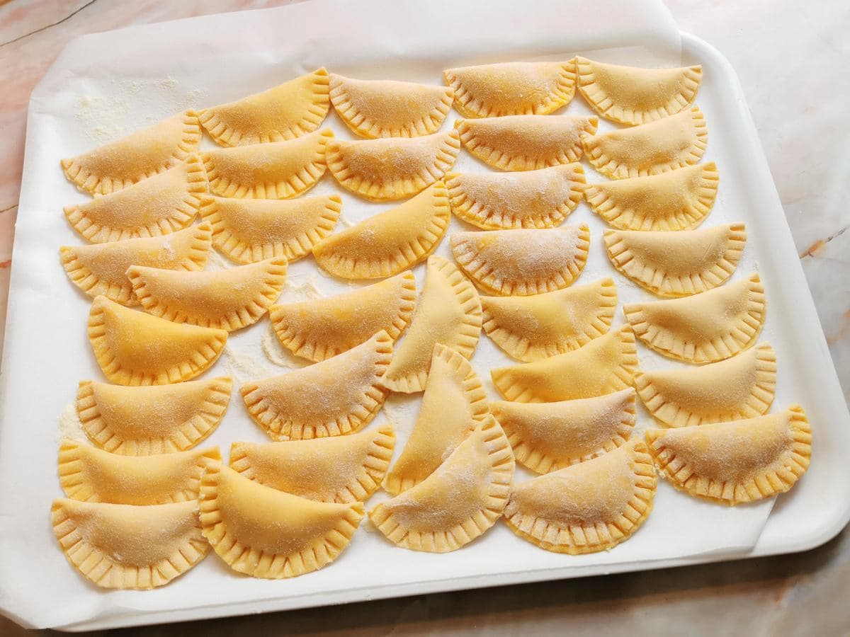 homemade ricotta ravioli on white tray