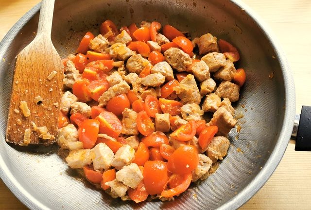 tuna chunks, onions and cut cherry tomatoes in frying pan