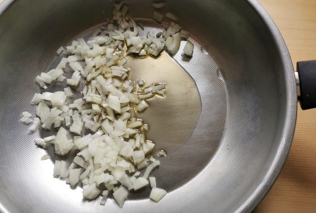 chopped onions in frying pan with olive oil