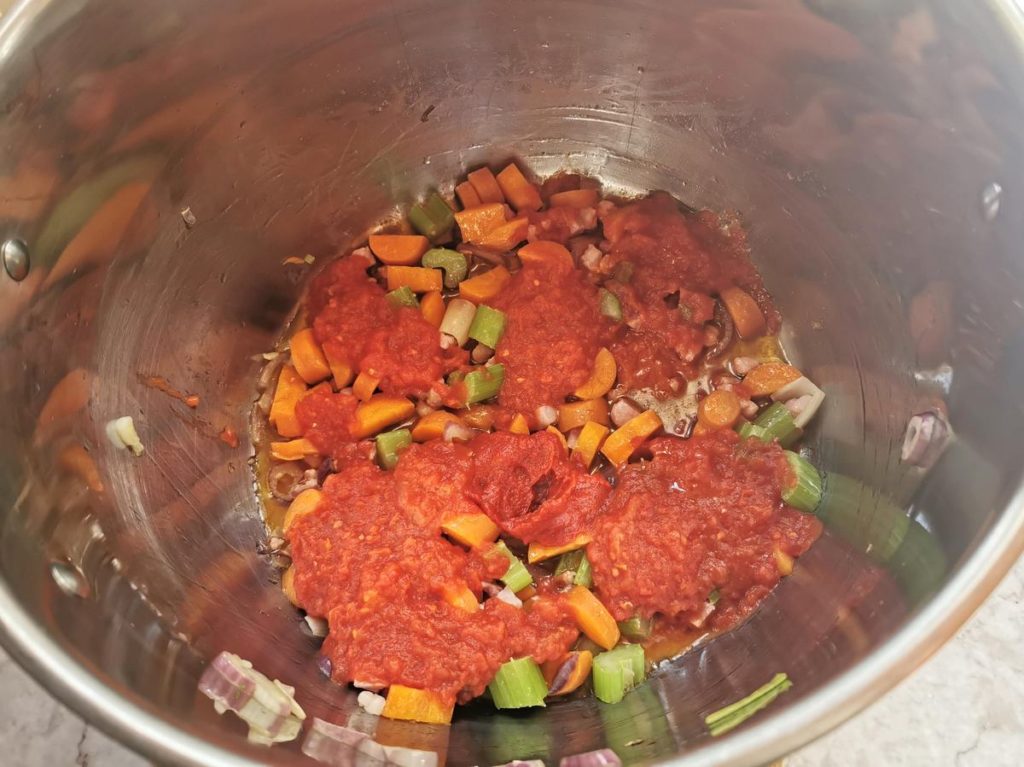 the tomato paste and passata added to the soffritto in deep pan.