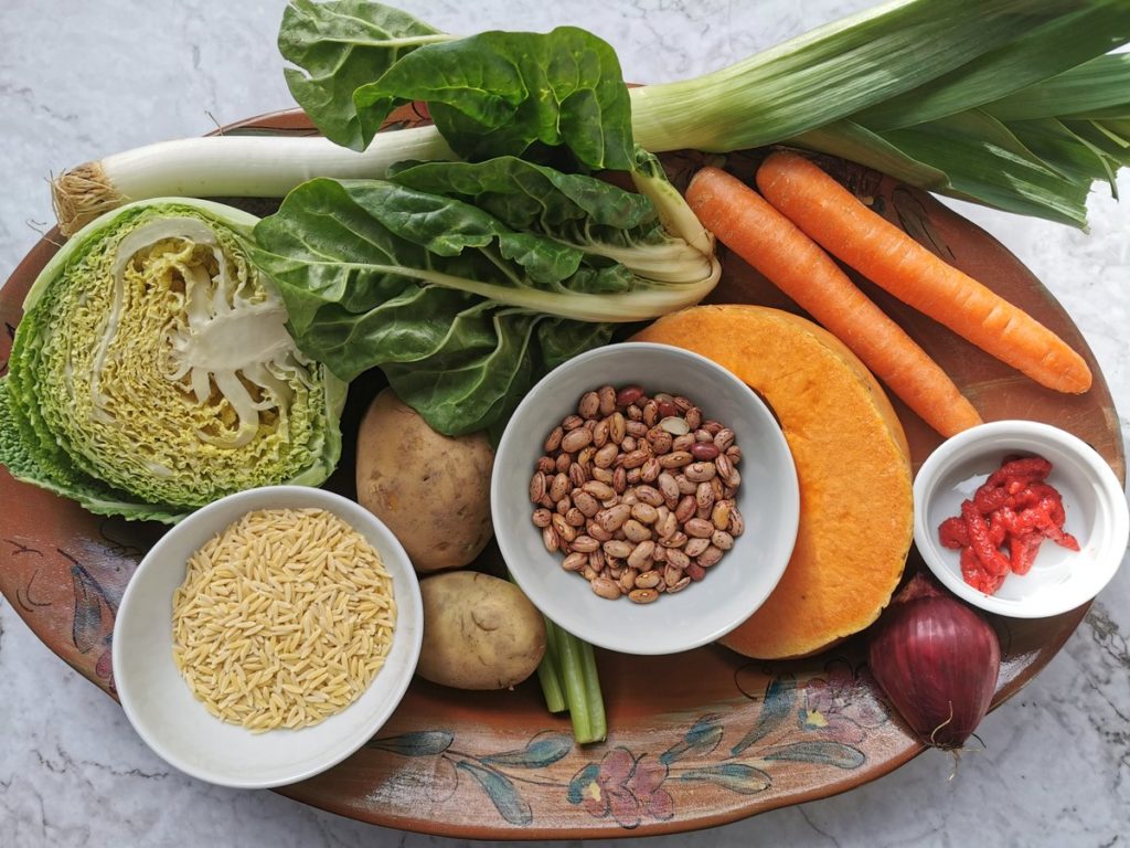 Ingredients for this Tuscan minestrone on an oval terracotta plate